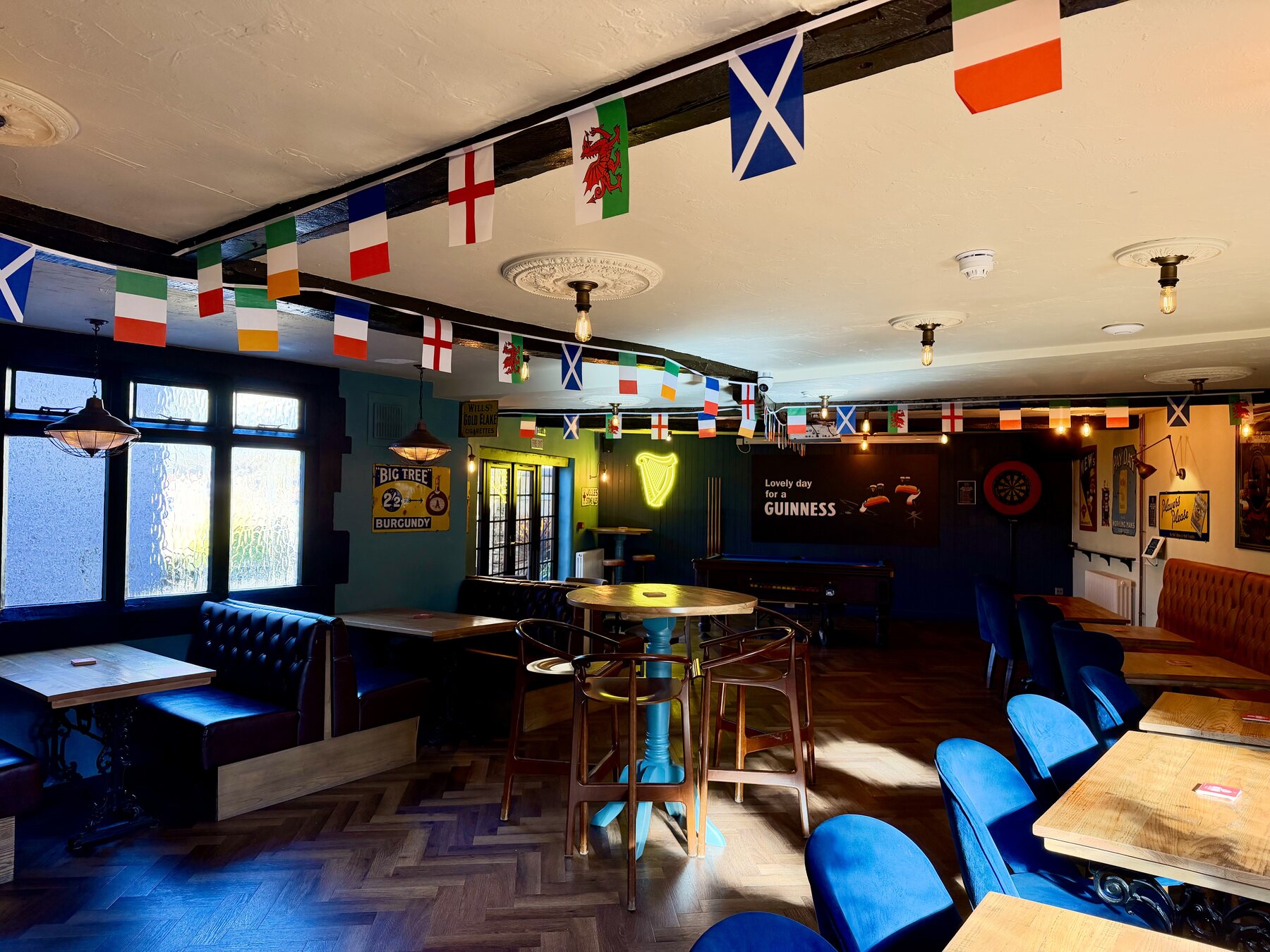 Inside Deans Walk Inn, with seating, pool table and flags